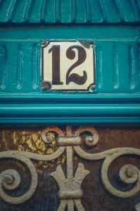Apartment number 12 on rustic blue door
