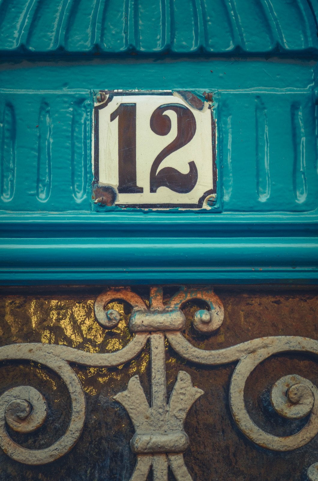 Apartment number 12 on rustic blue door
