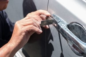 Car locksmith specialist unlocking door