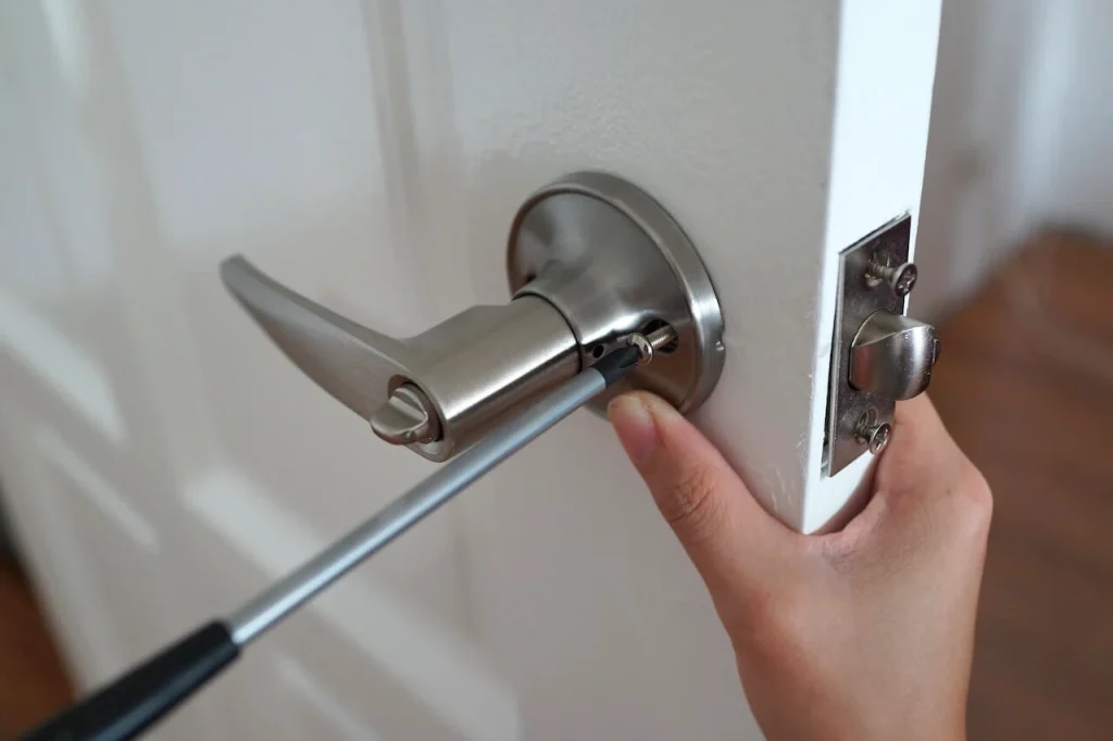 Locksmith installs the new door lock in new house