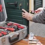 Professional locksmith repair a door lock