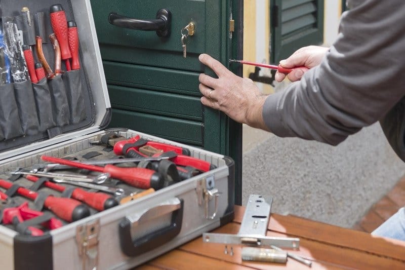 Professional locksmith repair a door lock