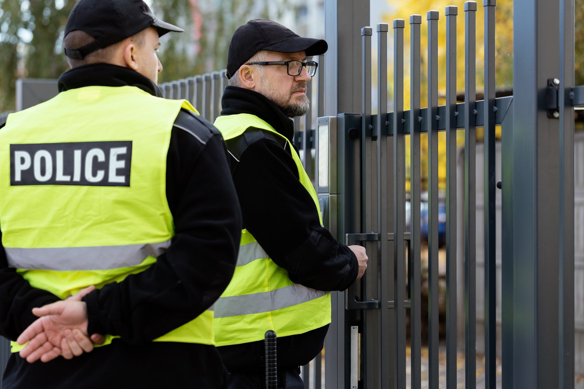 Two policemen in front of the entrance gate.