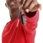 Young man holding car keys from Mobile Locksmith